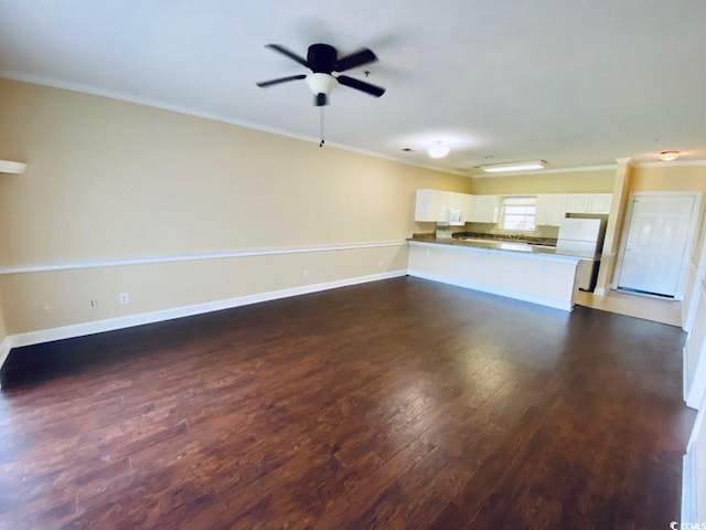 unfurnished living room featuring dark hardwood / wood-style flooring, ceiling fan, and ornamental molding