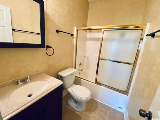 full bathroom with combined bath / shower with glass door, tile patterned floors, vanity, and toilet