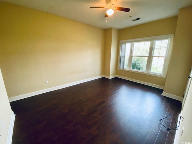 empty room featuring dark hardwood / wood-style floors and ceiling fan