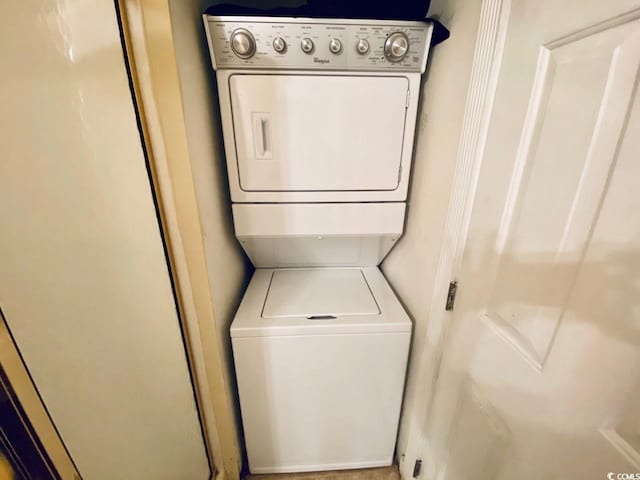 laundry room with stacked washer / dryer