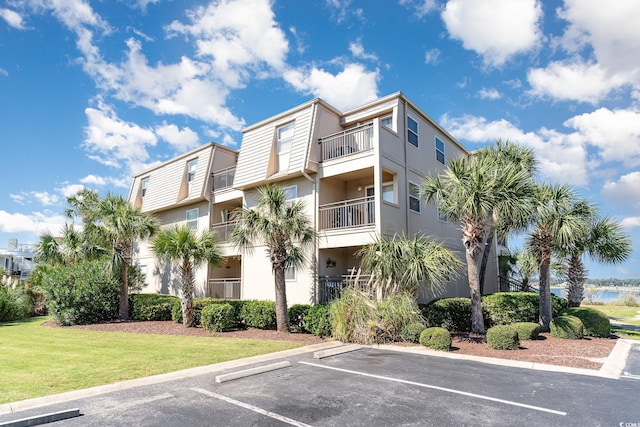 1582 S Waccamaw Dr Unit 60, Garden City Beach, SC 29576 - view of building exterior with a water view and uncovered parking
