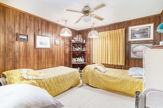 1582 S Waccamaw Dr Unit 60, Garden City Beach, SC 29576 - bedroom featuring wooden walls, a ceiling fan, and carpet flooring