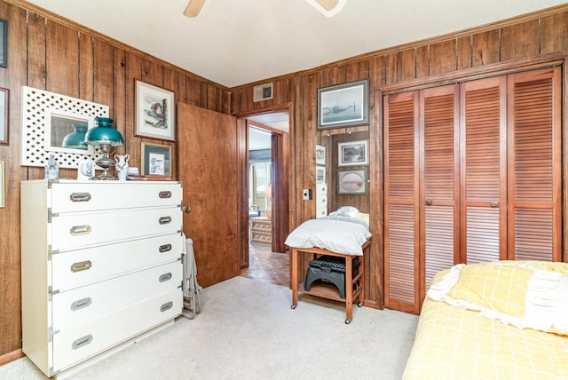 1582 S Waccamaw Dr Unit 60, Garden City Beach, SC 29576 - bedroom featuring light colored carpet, visible vents, a closet, wooden walls, and ornamental molding