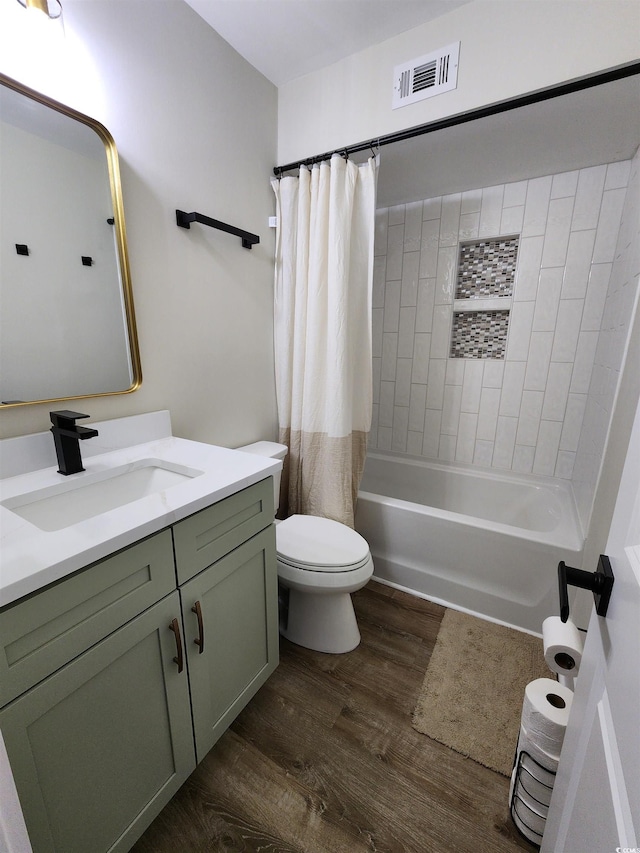 full bathroom with hardwood / wood-style floors, shower / bath combo, toilet, and vanity