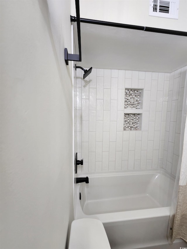 bathroom featuring shower / bath combo with shower curtain and toilet