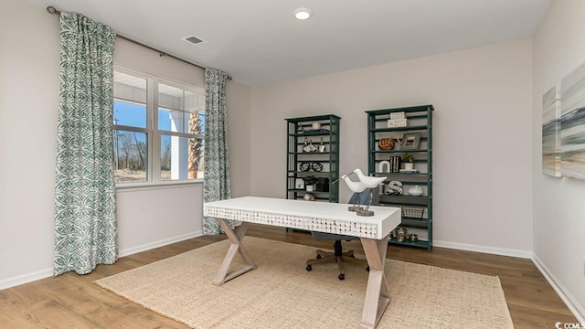 home office with wood-type flooring