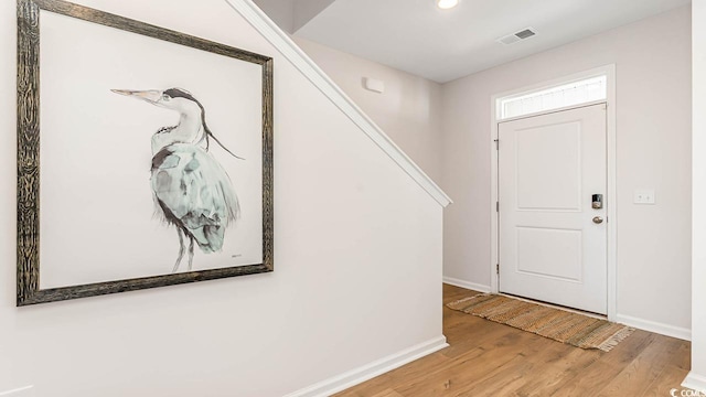 entryway with hardwood / wood-style floors