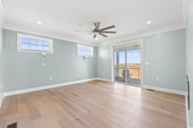 spare room featuring ornamental molding, light wood-type flooring, and ceiling fan