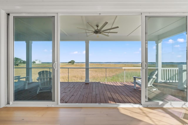 doorway to outside featuring hardwood / wood-style flooring, ceiling fan, and a rural view