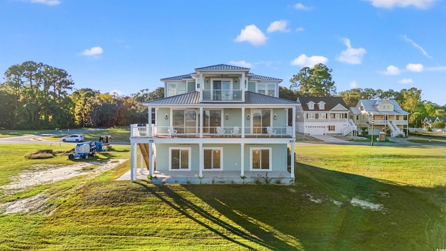 back of house with a balcony and a lawn