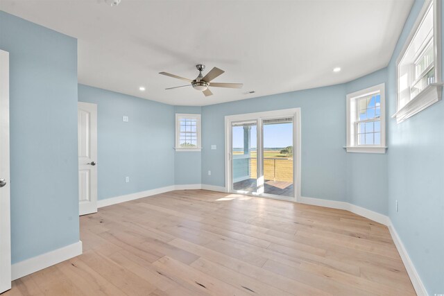 spare room featuring light hardwood / wood-style floors and ceiling fan