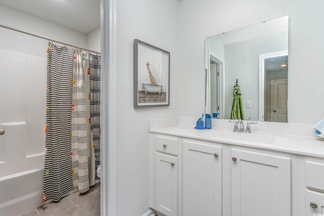 bathroom featuring vanity, shower / bath combo, and tile patterned flooring