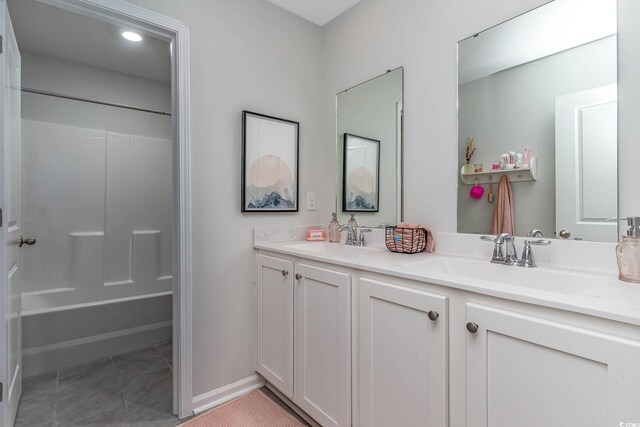 bathroom with vanity, washtub / shower combination, and tile patterned floors