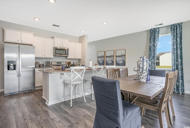 dining area featuring dark wood-type flooring