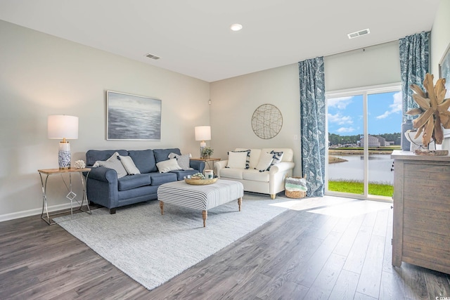 living room with a water view and wood-type flooring