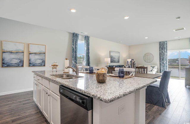 kitchen with dishwasher, white cabinets, sink, and an island with sink