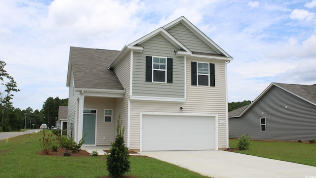 view of front of property with a garage and a front lawn