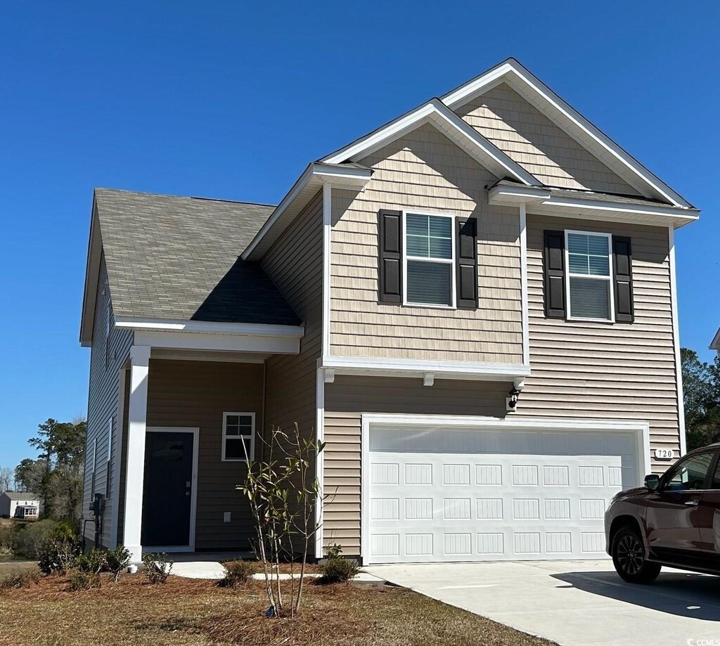 view of front facade featuring a front yard and a garage