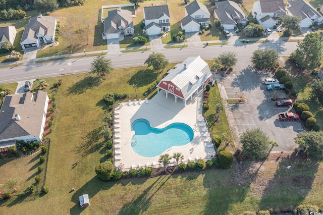 aerial overview of property's location with a pool and nearby suburban area