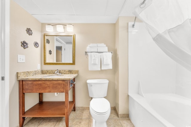 2504 N Ocean Blvd Unit 1736, Myrtle Beach, SC 29577 - bathroom featuring toilet, vanity, a paneled ceiling, baseboards, and tile patterned flooring