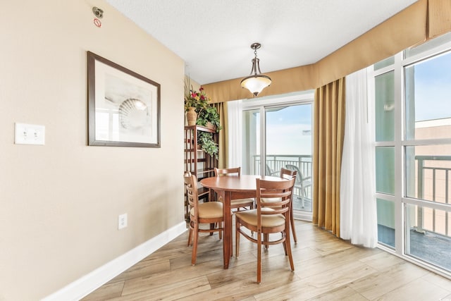 2504 N Ocean Blvd Unit 1736, Myrtle Beach, SC 29577 - dining area with light wood-style floors and baseboards