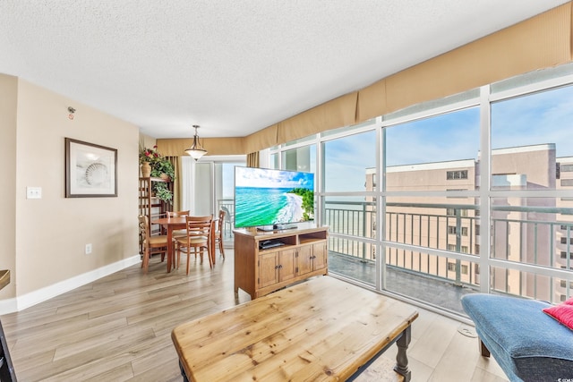 2504 N Ocean Blvd Unit 1736, Myrtle Beach, SC 29577 - living area featuring a textured ceiling, light wood-type flooring, and baseboards
