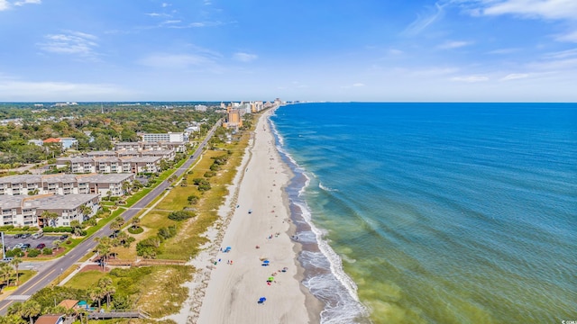 drone / aerial view featuring a water view and a beach view