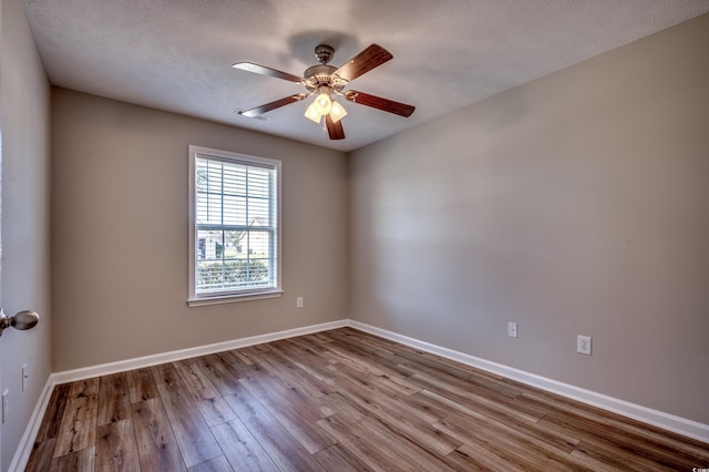 spare room with ceiling fan, light hardwood / wood-style floors, and a textured ceiling