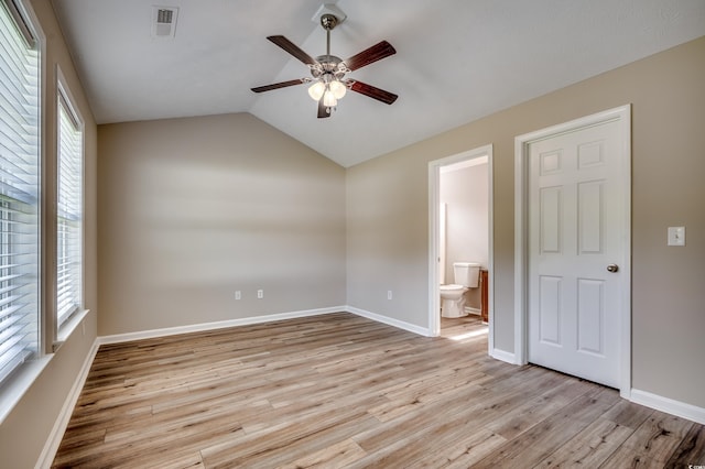 unfurnished bedroom with light hardwood / wood-style flooring, multiple windows, lofted ceiling, and ceiling fan