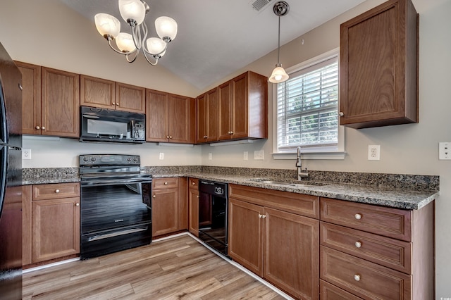 kitchen with black appliances, sink, light hardwood / wood-style flooring, vaulted ceiling, and a chandelier