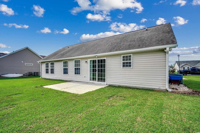 rear view of house featuring a patio area and a yard