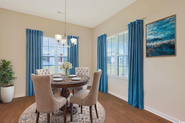 dining area featuring a notable chandelier and dark hardwood / wood-style floors