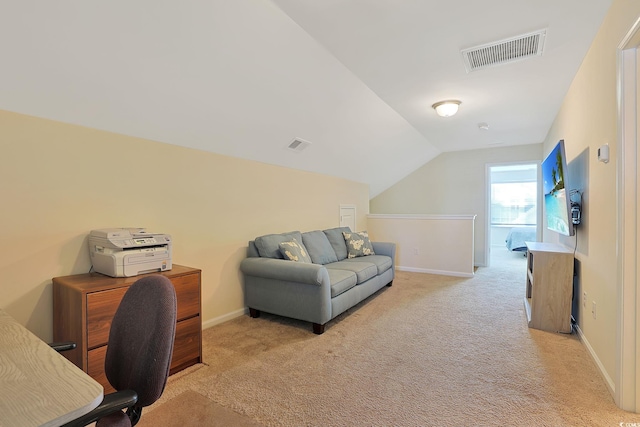 office space featuring light colored carpet and vaulted ceiling