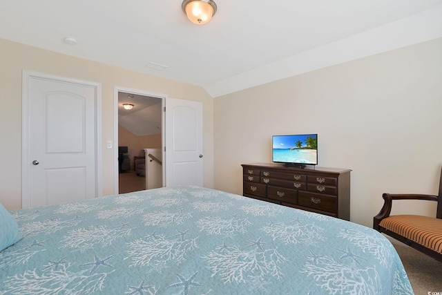 carpeted bedroom featuring lofted ceiling