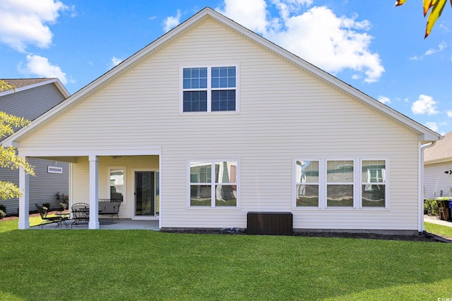 back of property featuring a patio and a yard