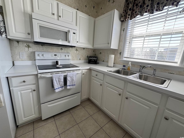 5801 Oyster Catcher Dr Unit 1531, North Myrtle Beach, SC 29582 - kitchen featuring white appliances, a sink, white cabinetry, and wallpapered walls