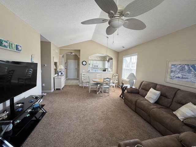 5801 Oyster Catcher Dr Unit 1531, North Myrtle Beach, SC 29582 - carpeted living room with ceiling fan, arched walkways, vaulted ceiling, a textured ceiling, and baseboards