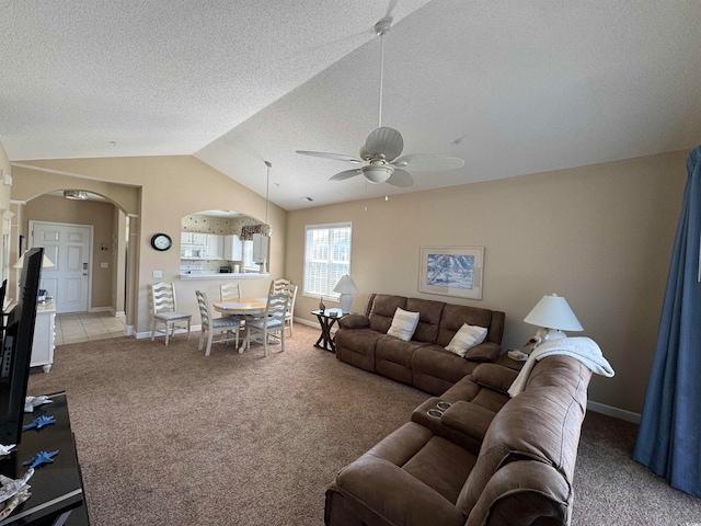 living room featuring carpet flooring, ceiling fan, a textured ceiling, and lofted ceiling