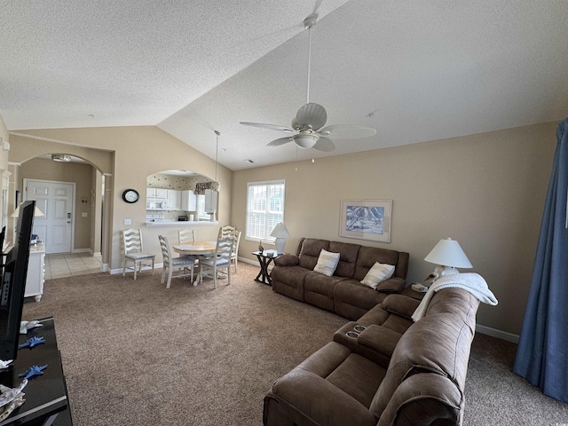 5801 Oyster Catcher Dr Unit 1531, North Myrtle Beach, SC 29582 - carpeted living area with arched walkways, ceiling fan, vaulted ceiling, baseboards, and a textured ceiling