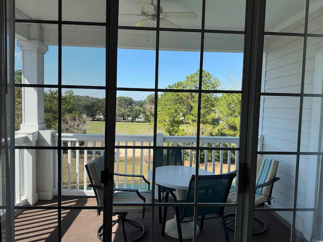 sunroom with ceiling fan and plenty of natural light