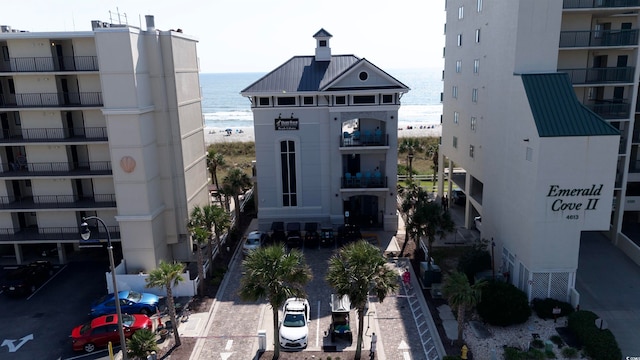 view of building exterior with a water view and central air condition unit