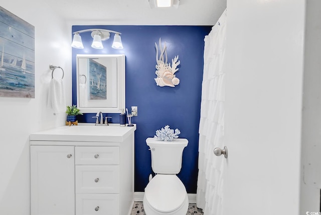 bathroom with tile patterned floors, vanity, and toilet