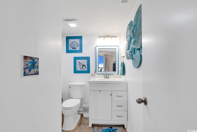 bathroom with vanity, tile patterned flooring, toilet, and a textured ceiling