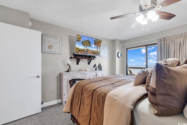 bedroom with a textured ceiling, light colored carpet, ceiling fan, and access to outside