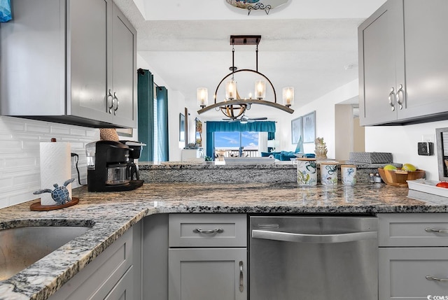 kitchen featuring dishwasher, dark stone countertops, a chandelier, and gray cabinetry