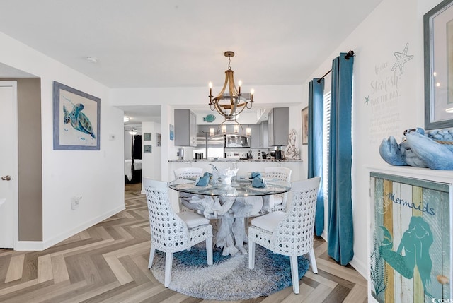 dining space featuring an inviting chandelier and light parquet floors