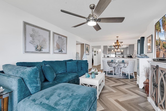 living room with ceiling fan with notable chandelier and light parquet floors