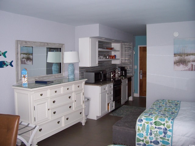 kitchen with sink, white cabinetry, and tasteful backsplash