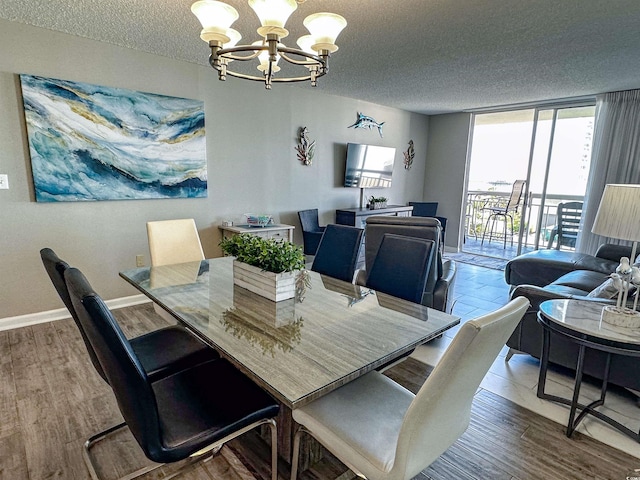 dining space featuring an inviting chandelier, a textured ceiling, and wood-type flooring