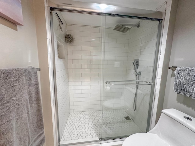 bathroom featuring baseboard heating, toilet, and walk in shower